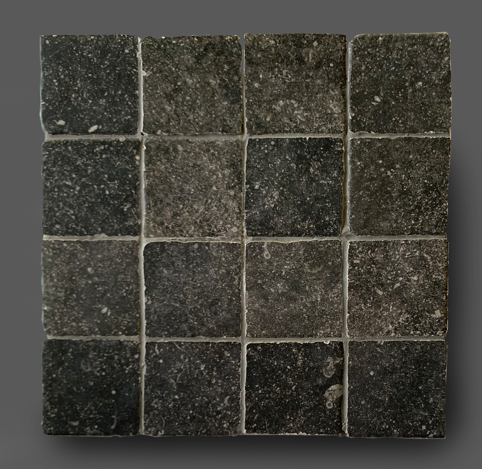 Vloertegel 10x10 cm romaans verband belgisch hardsteen zwart E12 Vloertegel 10x10 cm romaans verband belgisch hardsteen zwart E12 is ook leverbaar in 30x30 cm, 30x50 cm, 50x50 cm, 80x80 cm en in mix.